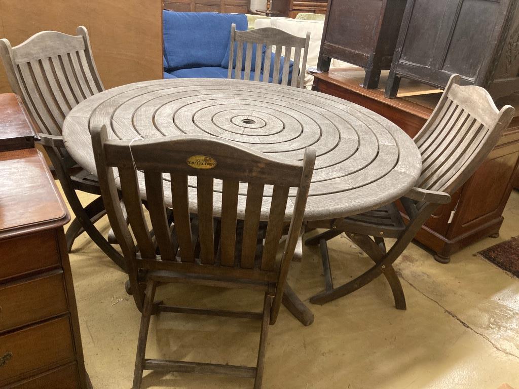 An Alexander Rose circular weathered teak garden table, diameter 144cm, height 71cm (no bolts) and four Kent collection folding chairs